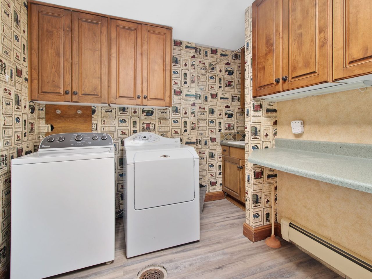 Laundry room with wood cabinets, a washer and a dryer