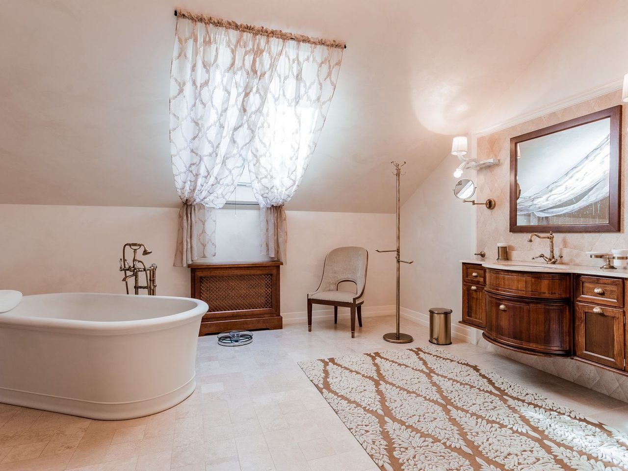 Bathroom with a freestanding tub, a vanity and a patterned rug