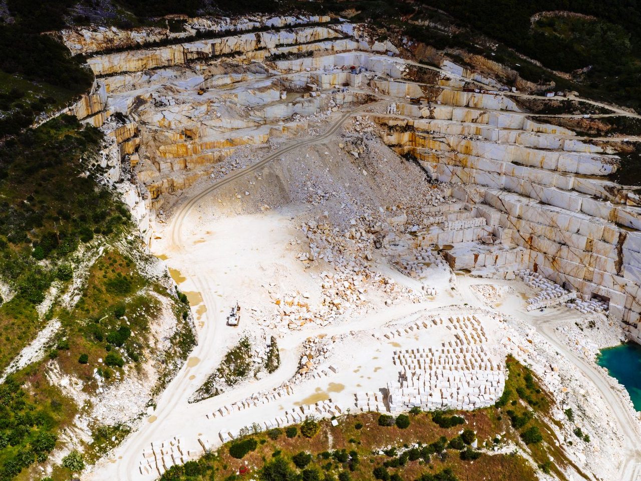 Aerial view of a marble quarry surrounded by greenery