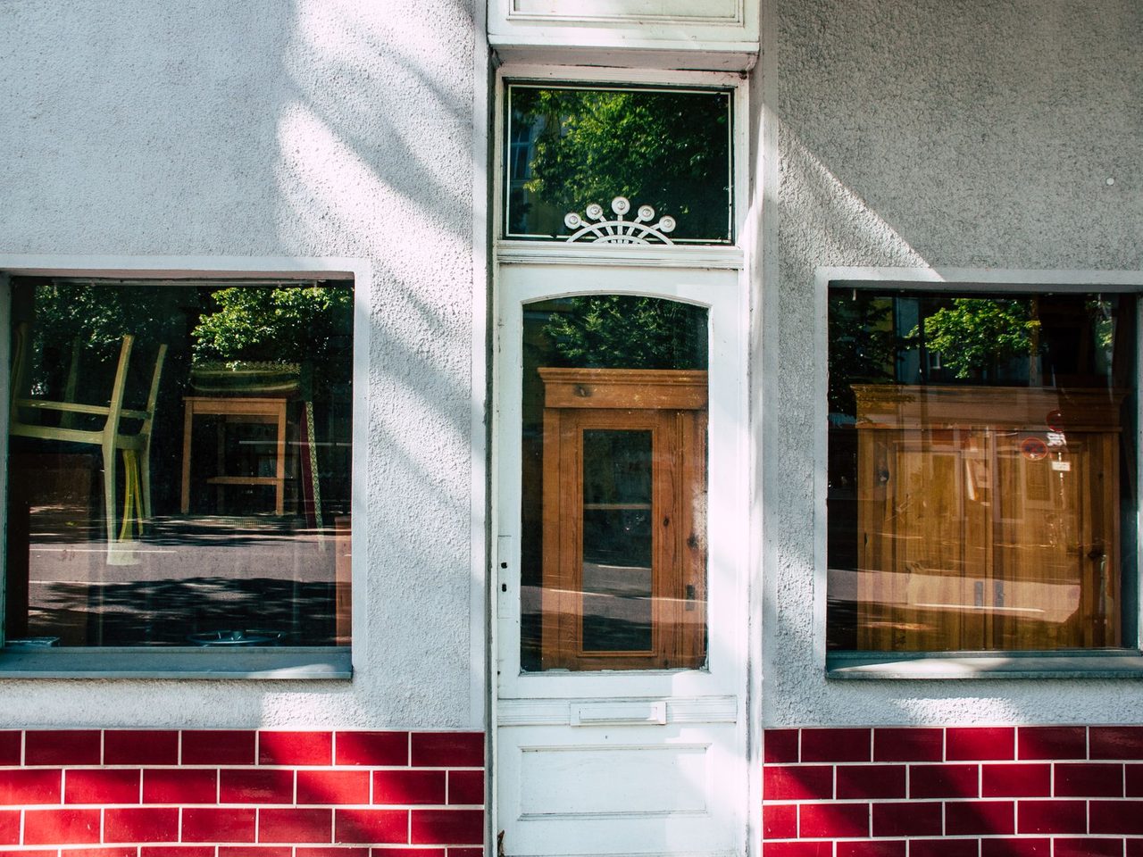 Shop front with two large display windows and a glazed door facing the street