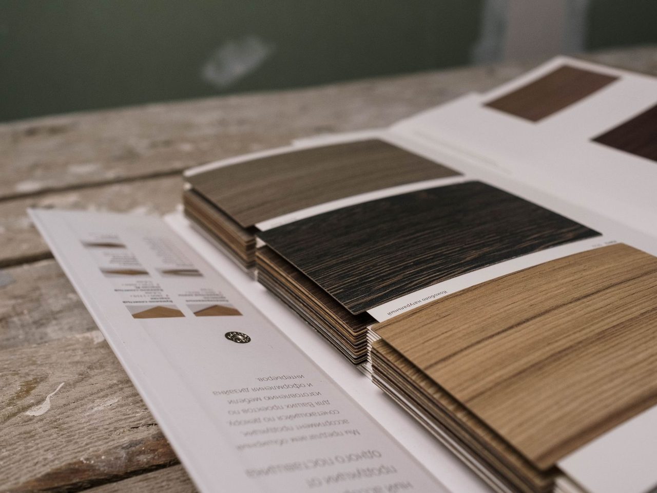 Wood veneer sample book fanned out on a rustic table