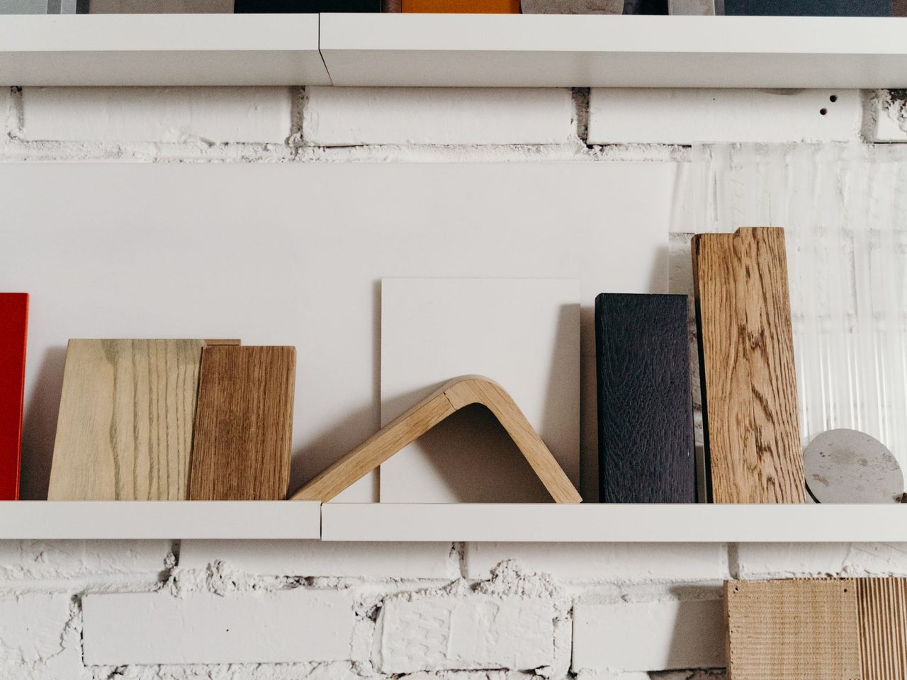 Wood and color samples standing on a white shelf