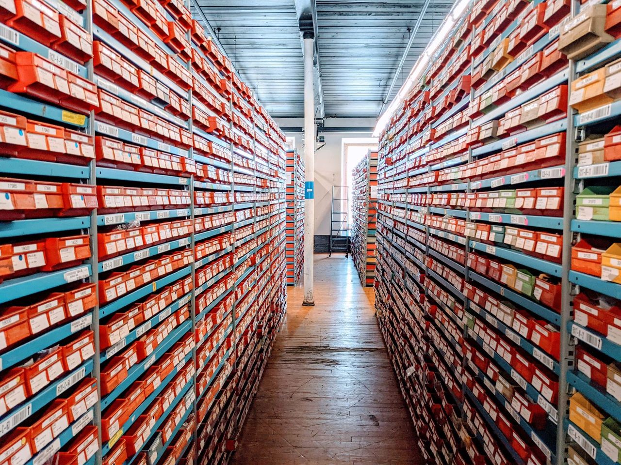 Warehouse aisle lined with shelves of boxed goods