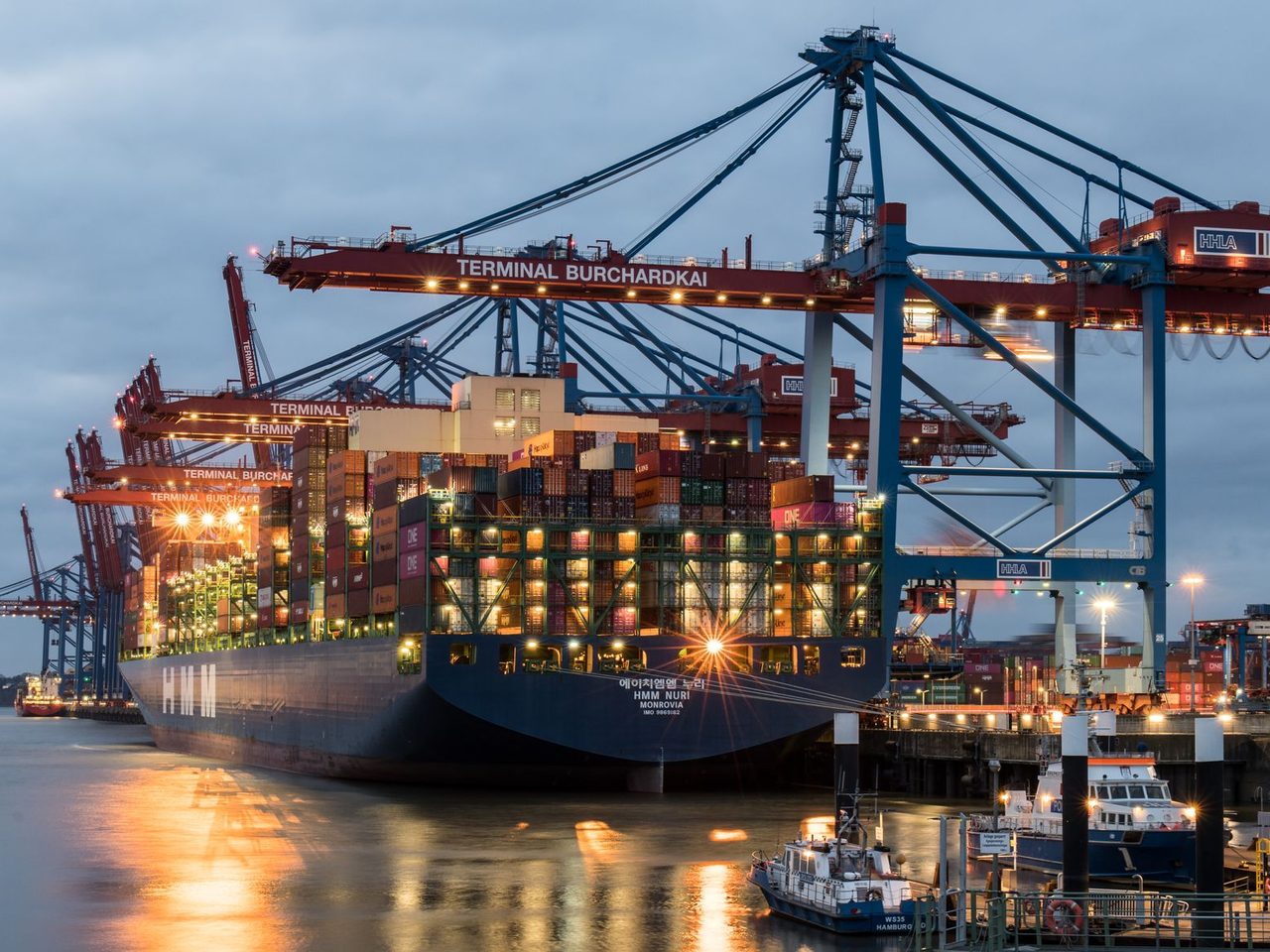 Container ships and cranes at a terminal in the evening
