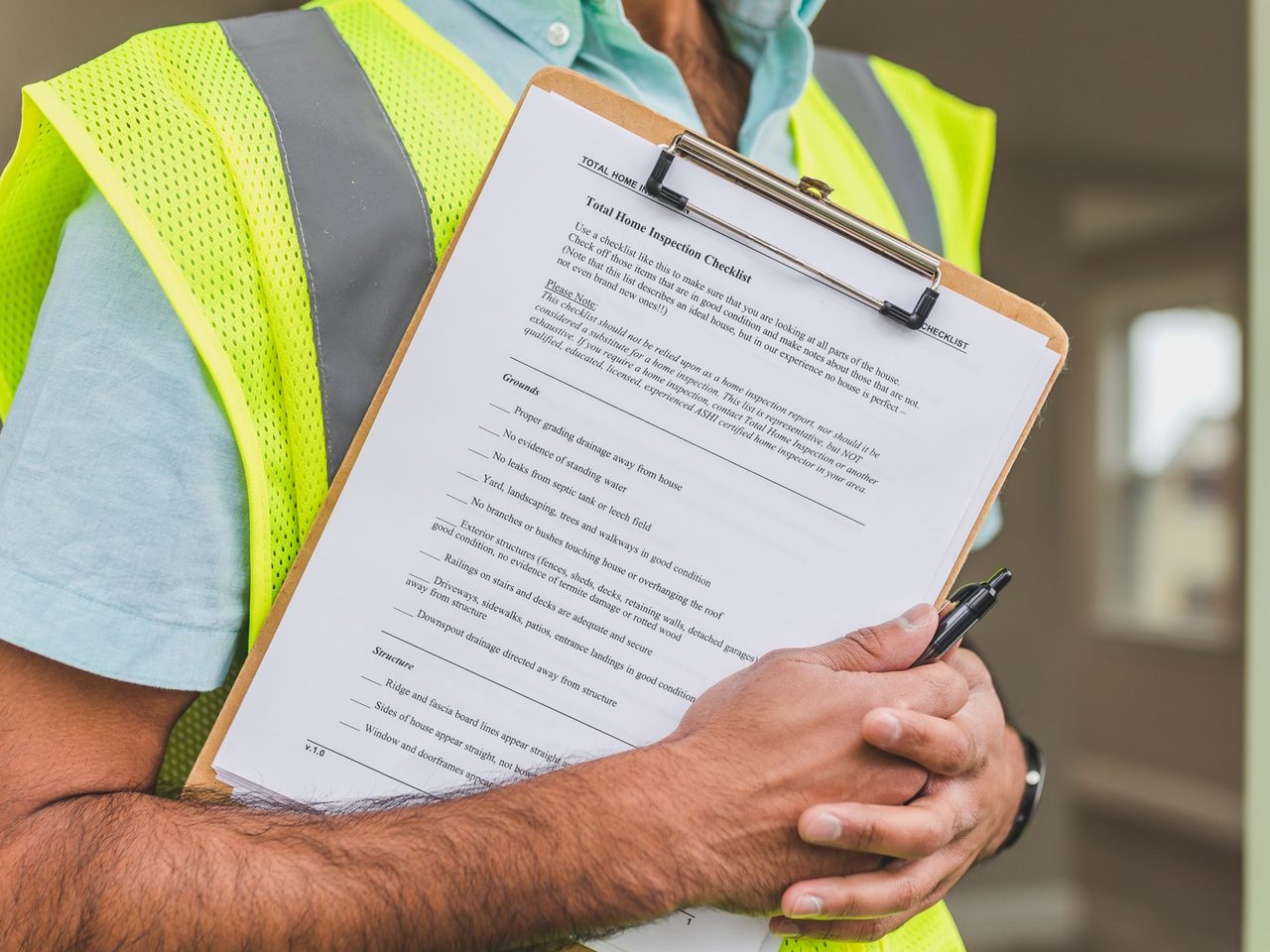 Close-up of a checklist on a clipboard held by someone in a safety vest
