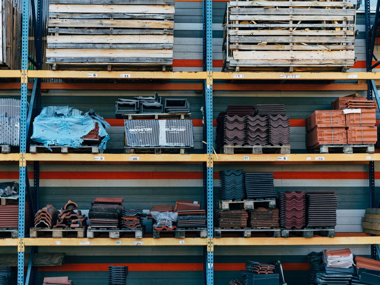 Warehouse shelving holding tiles, pallets and other building materials