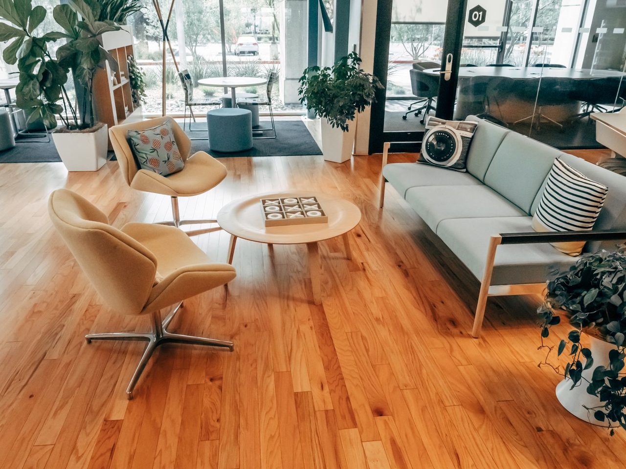Office lounge with wood flooring, armchairs and a low table