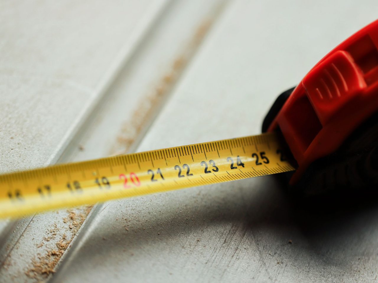 Close-up of a tape measure lying on a construction surface