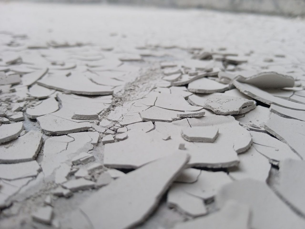 Close-up of a cracked and flaking concrete surface