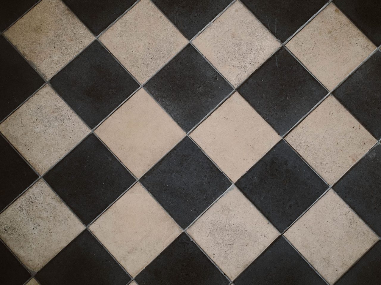 Black and white checkered floor tiles laid on the diagonal