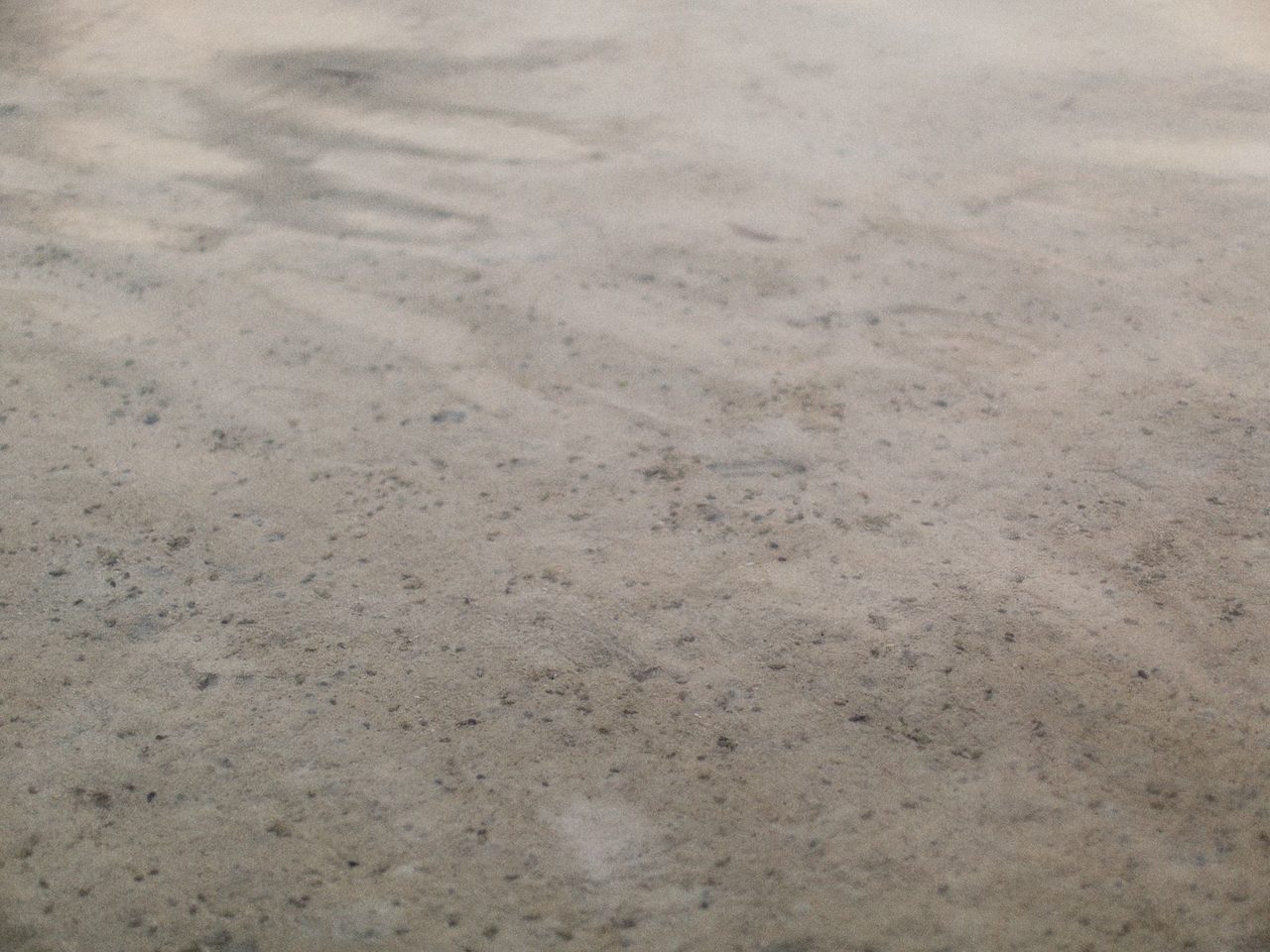 Close-up of a cured floor surface with a fine sandy texture