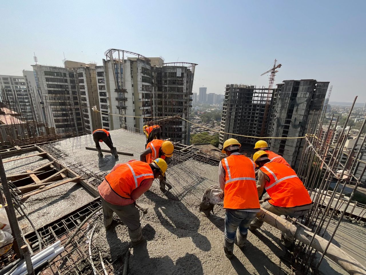 Workers on a multistory apartment building under construction