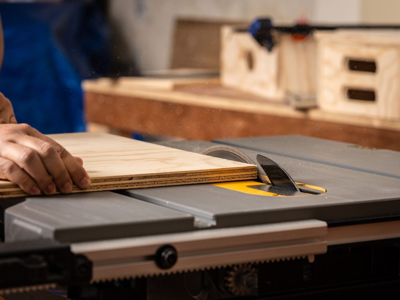 Plywood being cut on a table saw in a workshop
