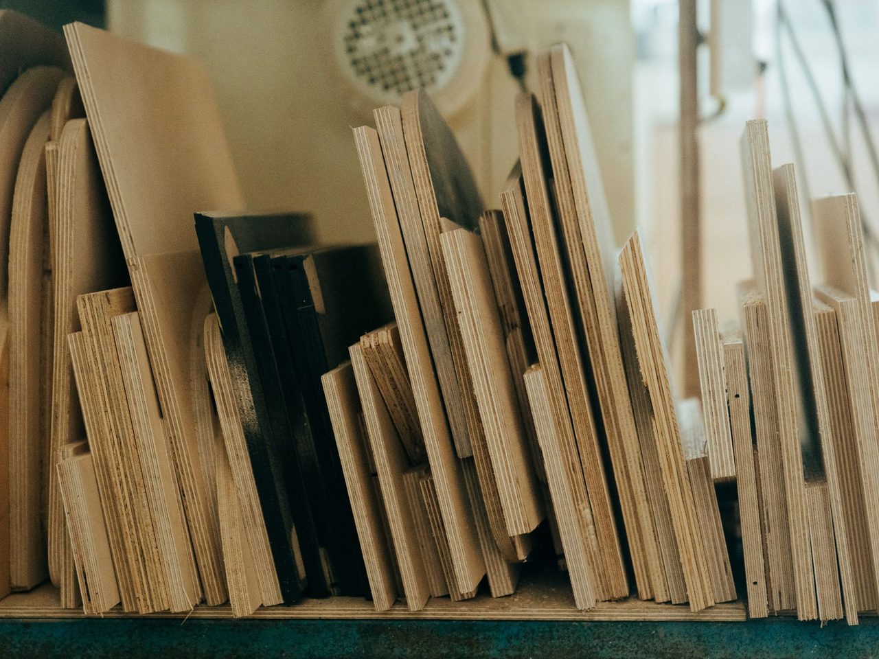 Wood boards and panels of various sizes standing in a workshop