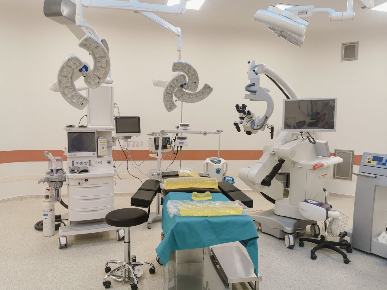 Operating room with surgical equipment standing on a seamless light floor