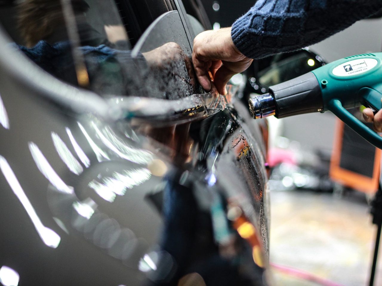 Close-up of a hand holding a heat gun