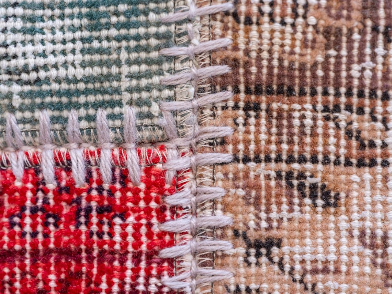 Close-up of woven textile showing yarn crossings and stitching