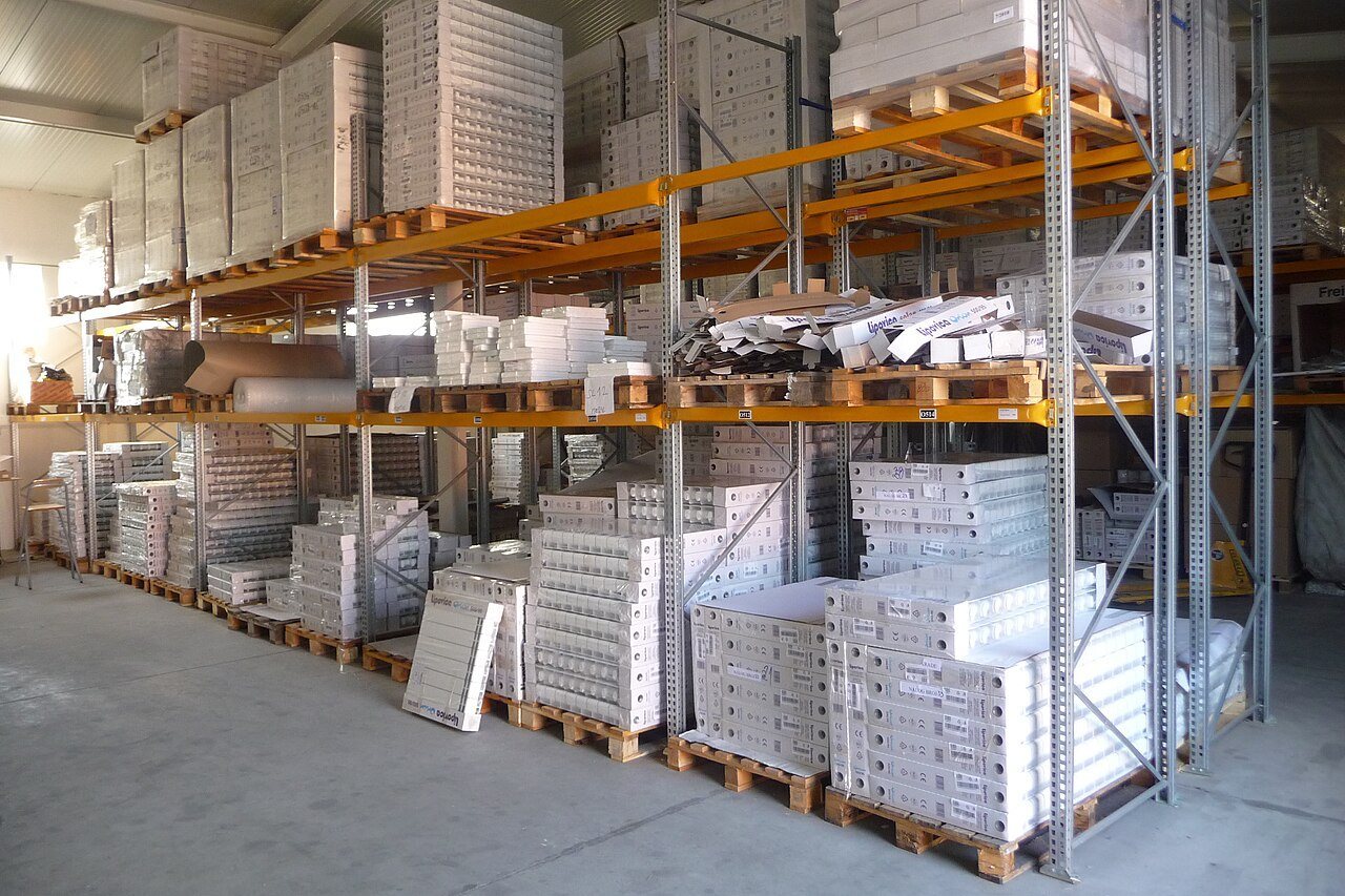Warehouse racking stacked with boxed goods on wooden pallets