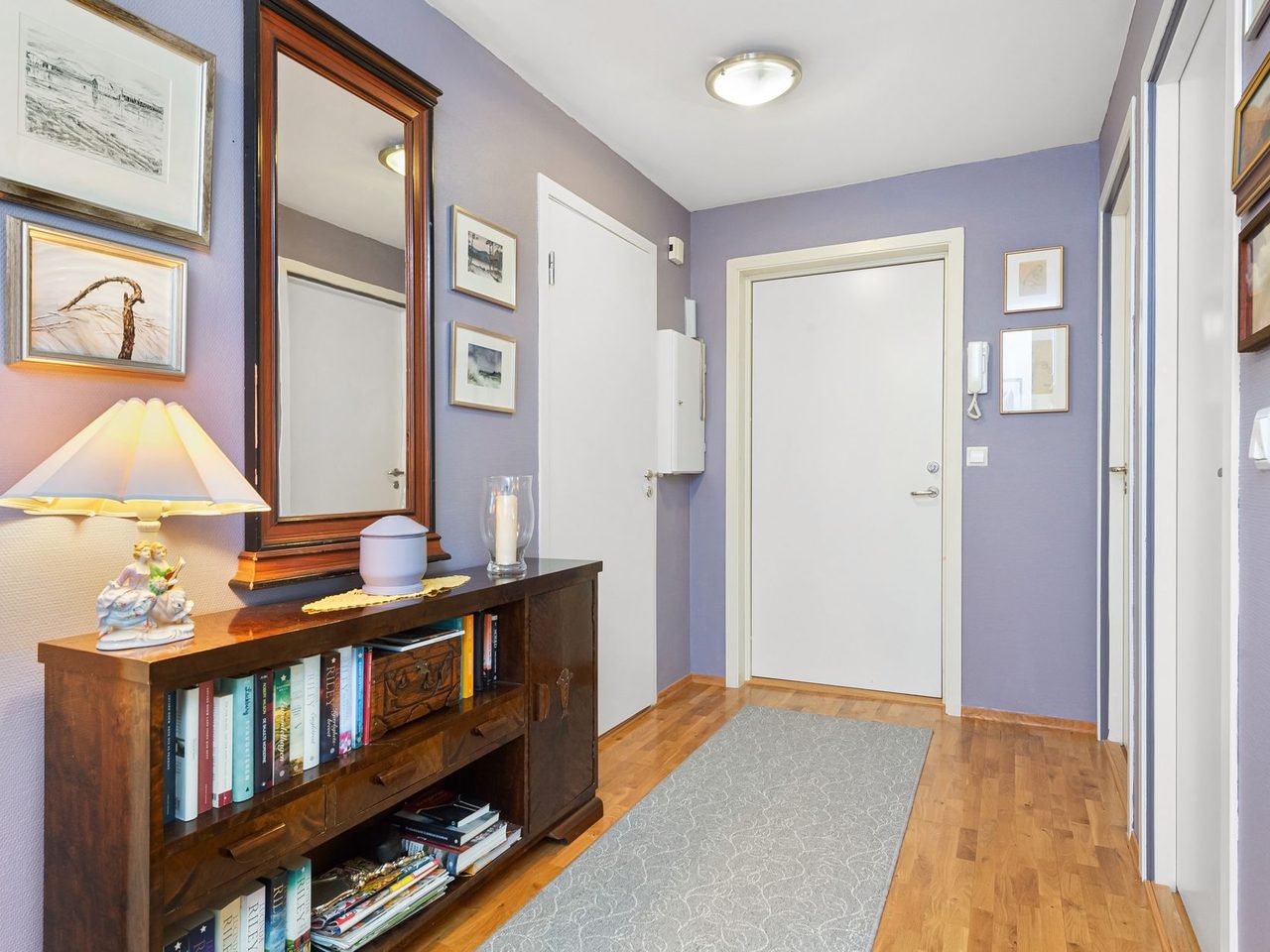 Hallway with a long gray runner rug on a wood floor