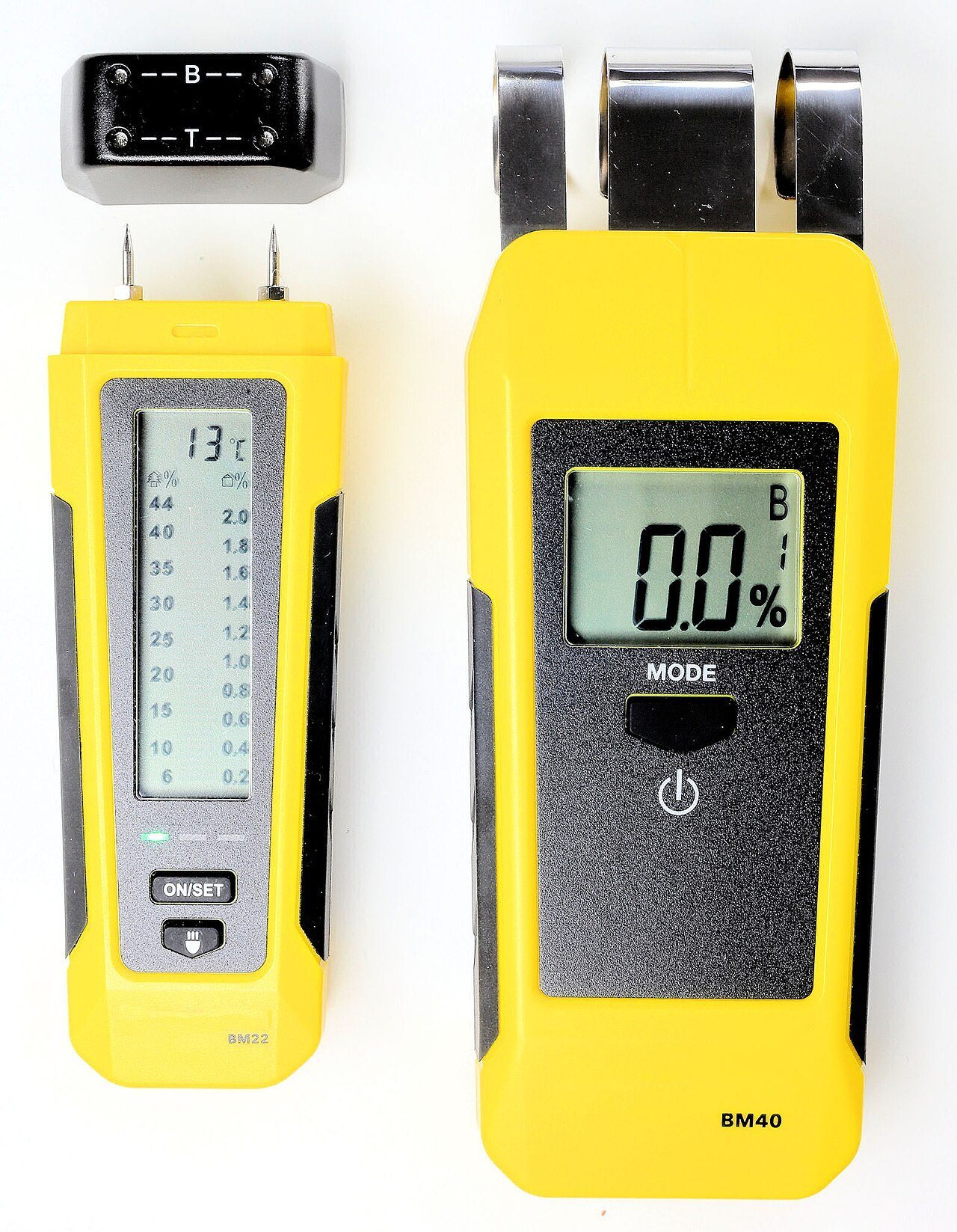 Two yellow handheld pin moisture meters with digital displays on a white background