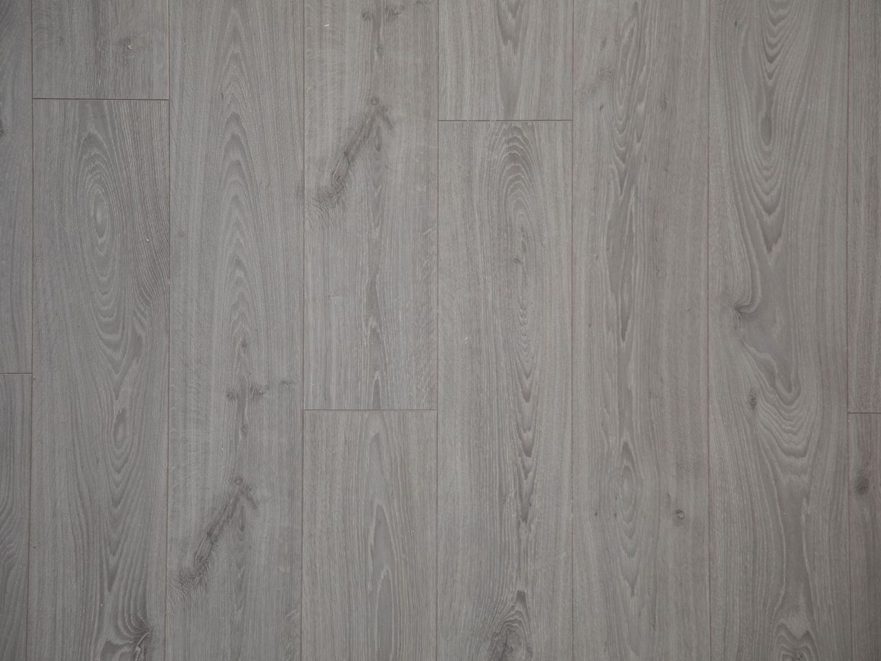 Close-up of a gray wood-look plank floor with staggered joints