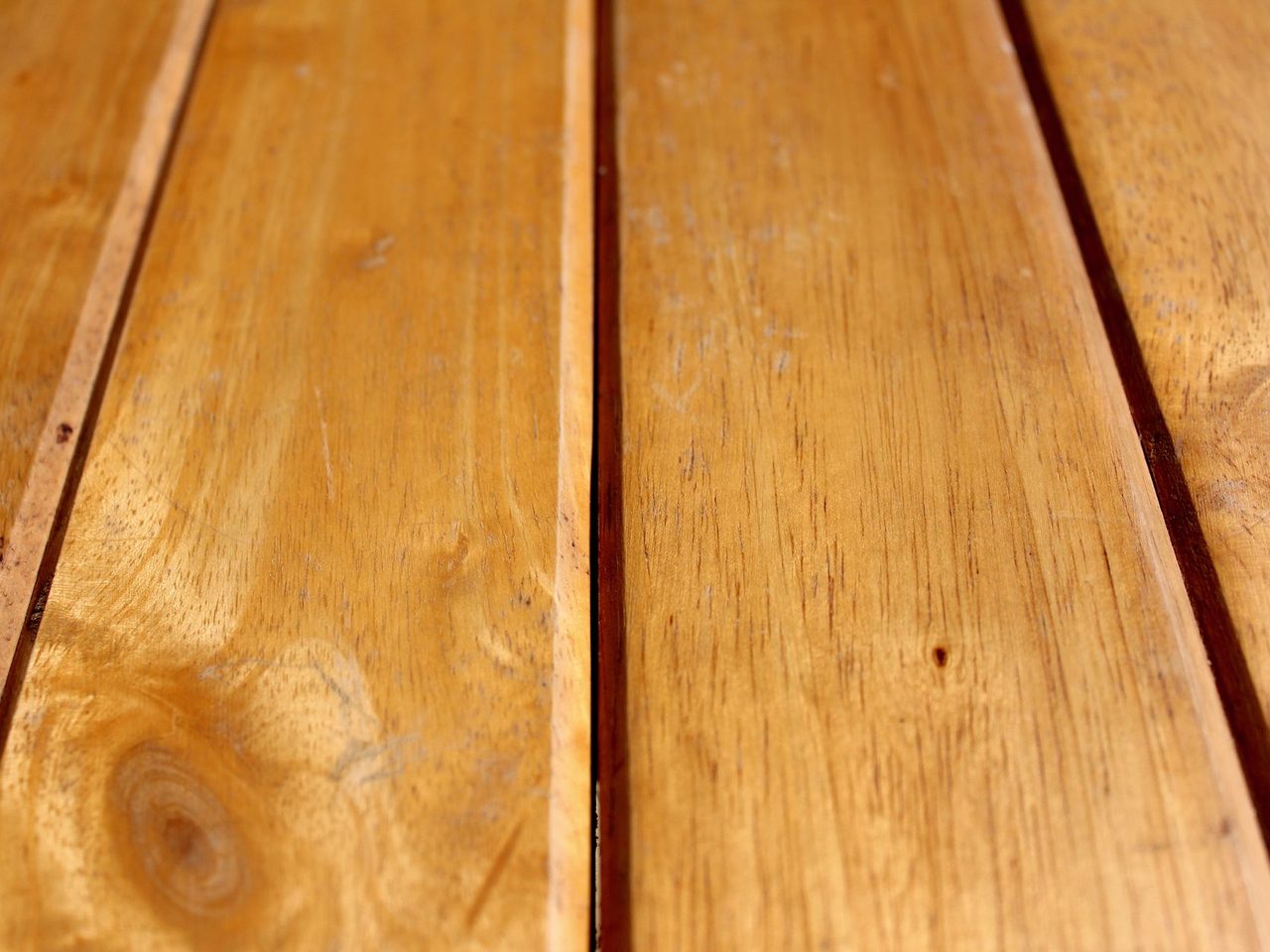 Natural wood planks with visible gaps along their long edges