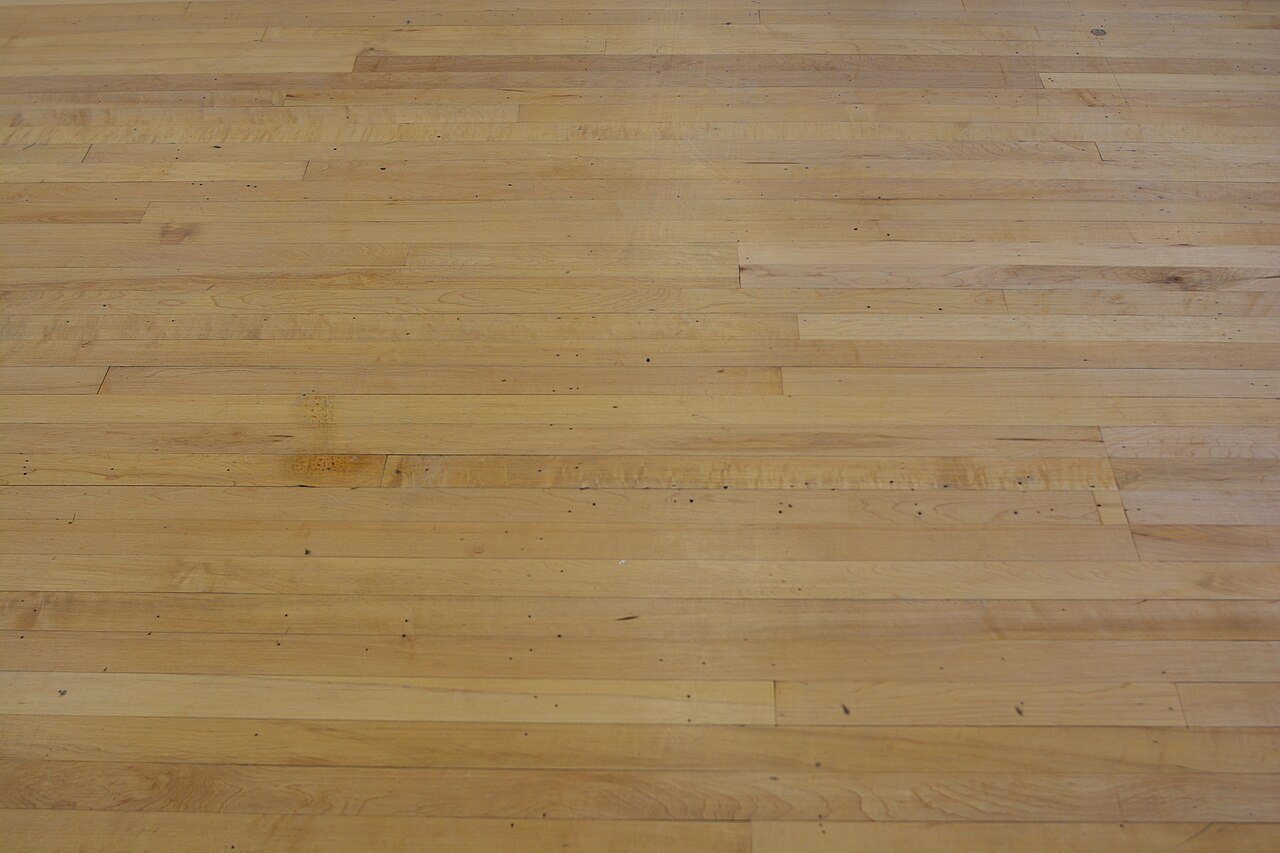 Close-up of a maple strip floor with random-length boards and staggered end joints