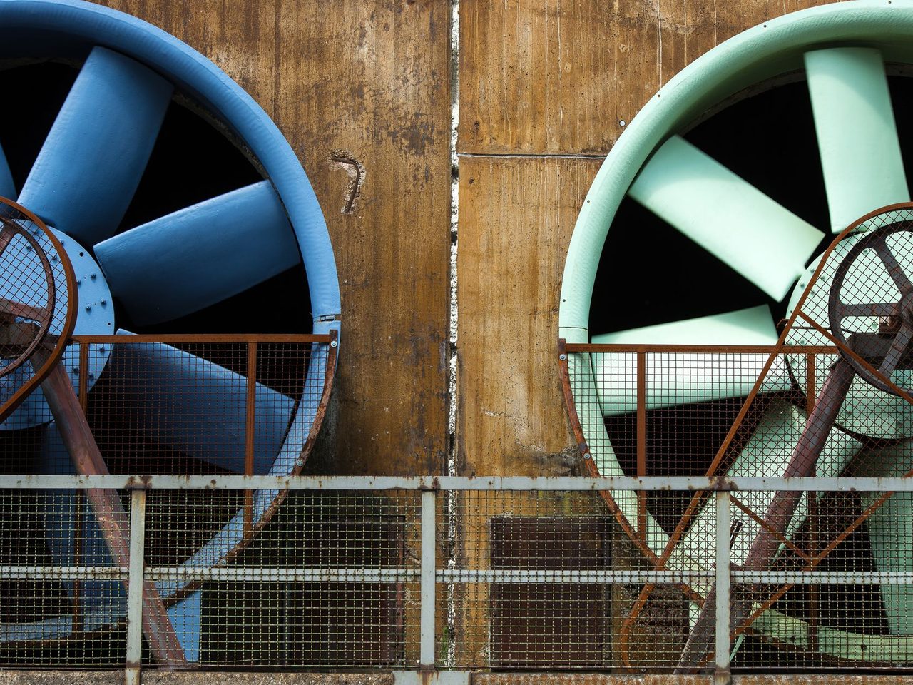 Large industrial ventilation fans mounted on a building exterior