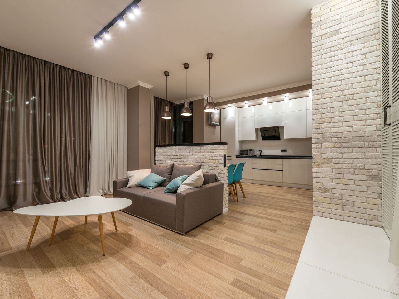 Apartment living room with a sofa, table and a light wood-look floor