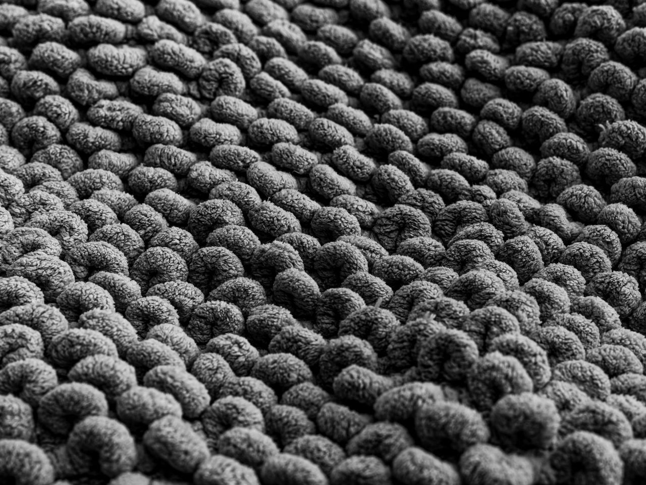 Monochrome close-up of a looped textile surface