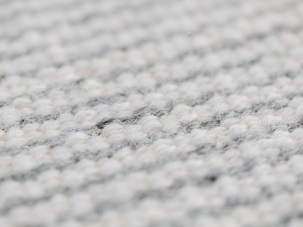 Close-up of a gray woven rug texture