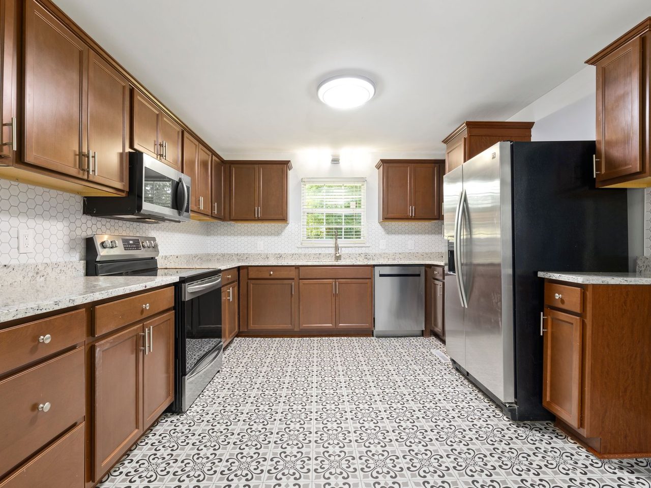 Kitchen with wooden cabinets and a patterned tile floor