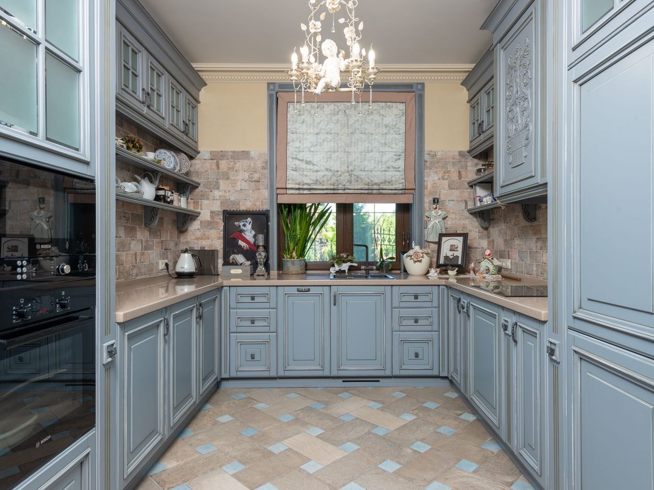 Vintage-style kitchen with pale blue cabinets and a patterned floor