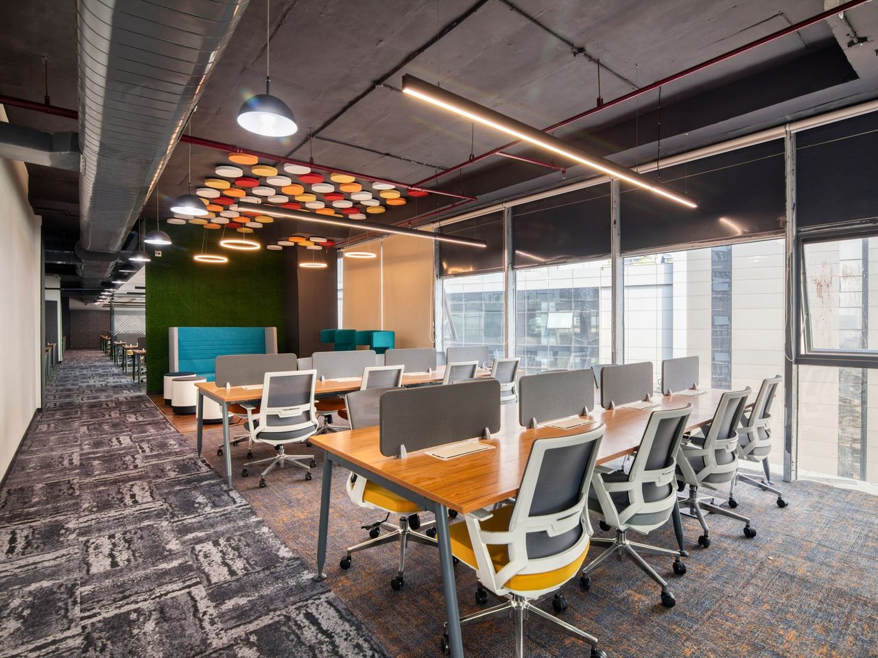 Open office with desks and chairs on patterned carpet