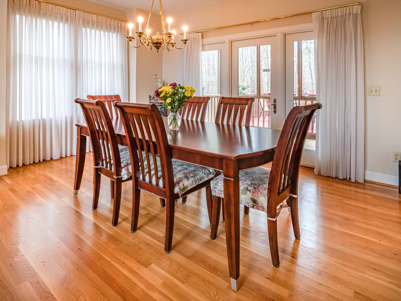 Dining room with a wooden table, chairs and a hardwood floor