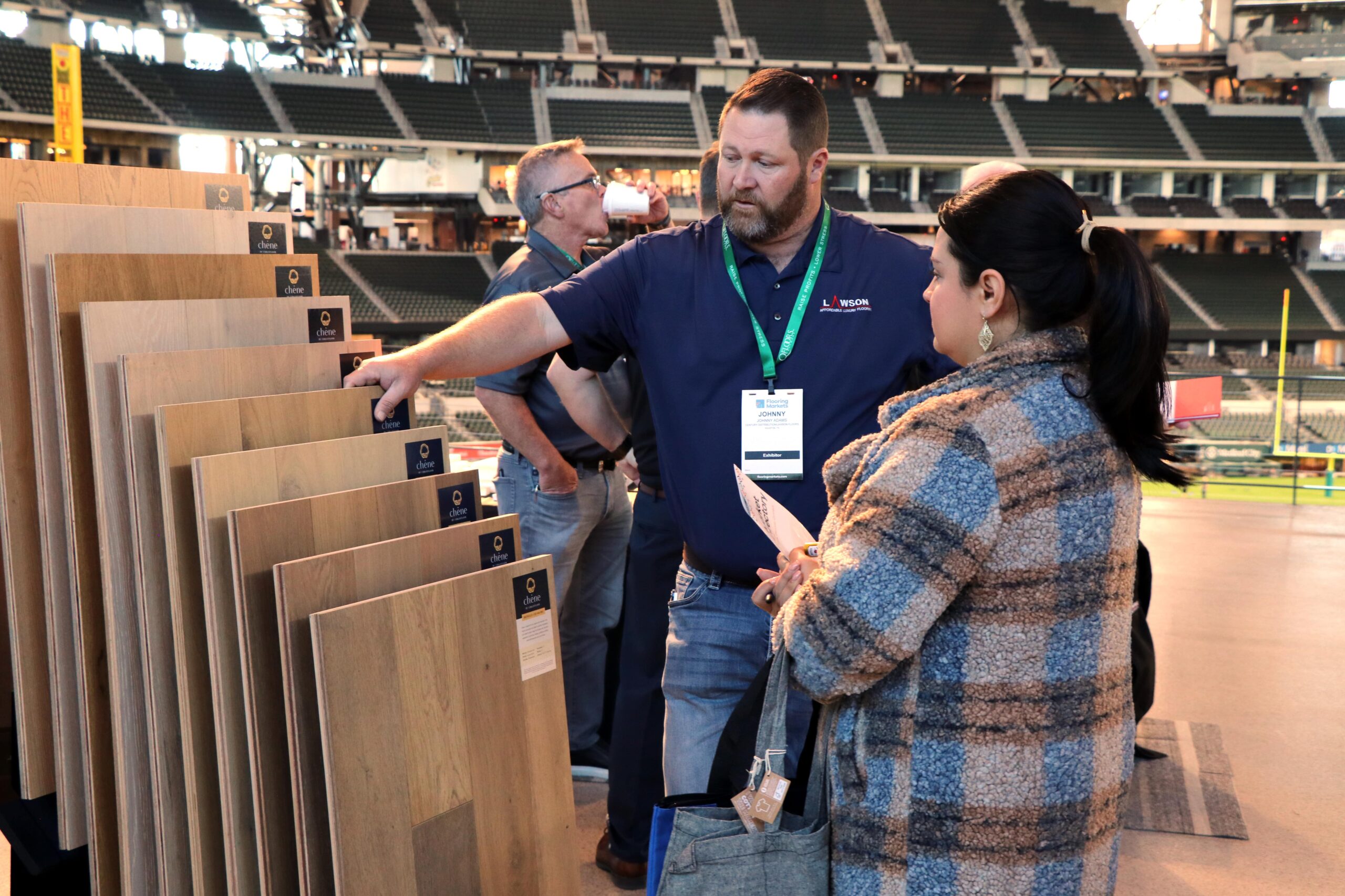 Busy regional flooring trade show floor with exhibitors and attendees