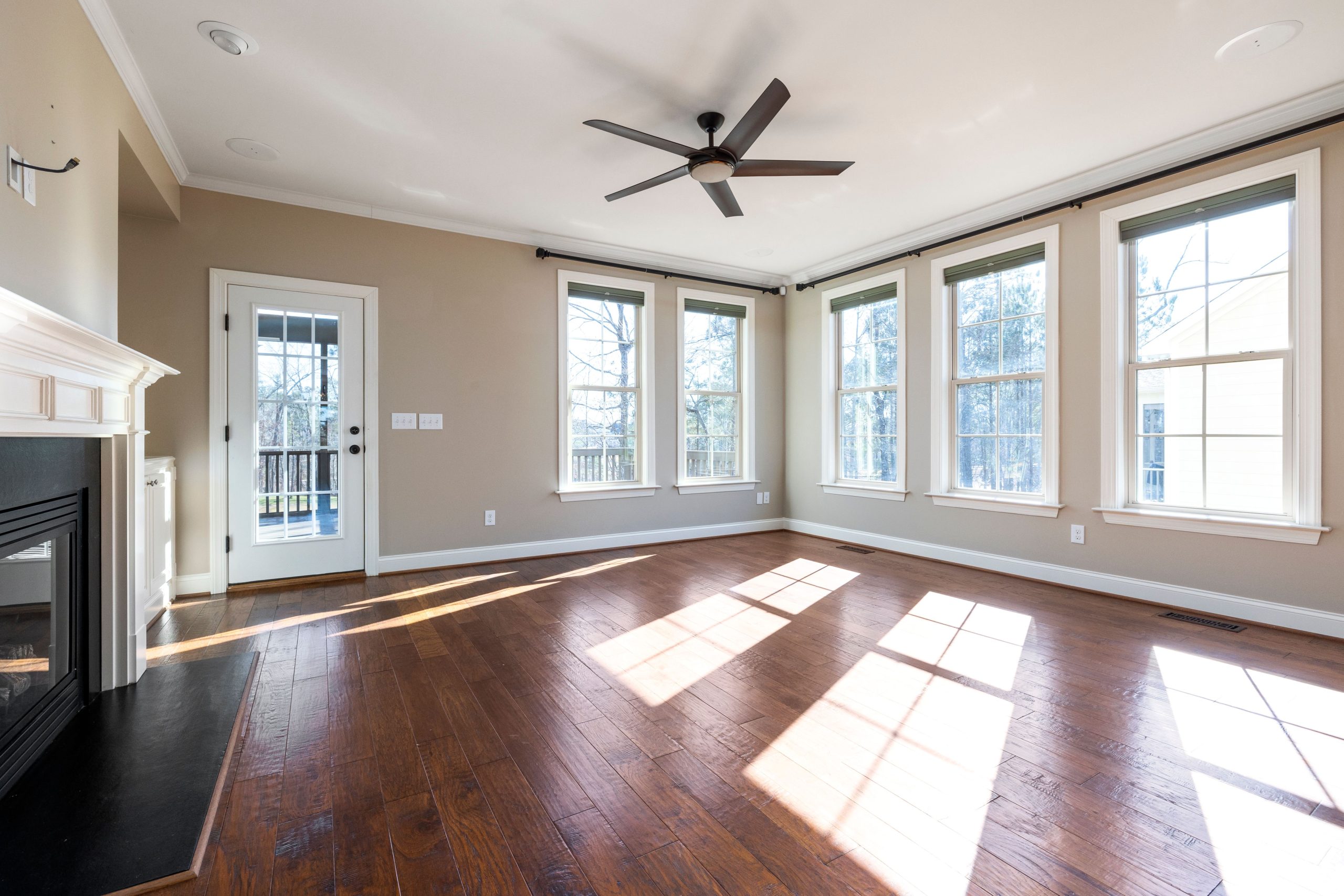 Bright living room with hardwood floor and large windows