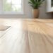 Luxury vinyl plank flooring edge curling upward at the room perimeter near baseboard trim