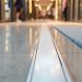 Flooring threshold profile transition between tile and carpet in a retail store entrance