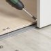 LVP transition strip installation showing proper gap sizing for a floating floor