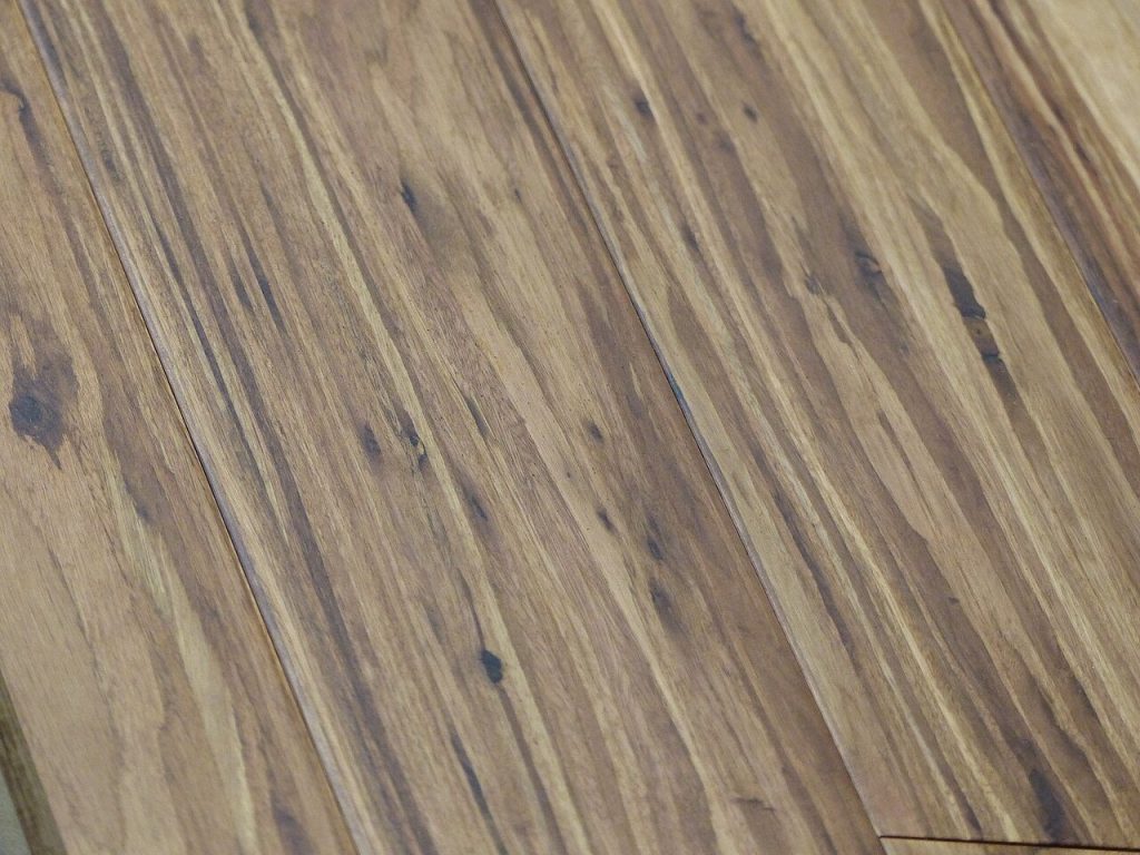 Close-up of strand-woven bamboo floor planks with streaky light and dark grain and bevelled edges
