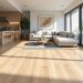 Wide-plank luxury vinyl flooring in a bright modern open-plan living space, a 2026 flooring trend