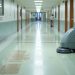 Worn VCT flooring showing maintenance mistakes that reduce floor life in a commercial hallway